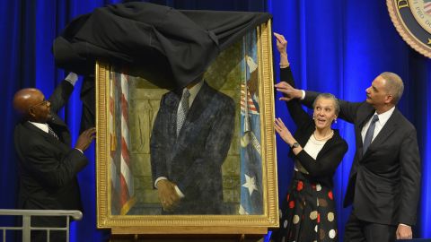A drape gets momentarily stuck as U.S. Attorney General Eric Holder and his wife, Sharon, help artist Simmie Knox unveil Holder's portrait at the Justice Department on Friday, February 27. Holder <a href="http://www.cnn.com/2015/04/24/politics/eric-holder-goodbye-ceremony/" target="_blank">resigned in April</a> and was replaced by Loretta Lynch.