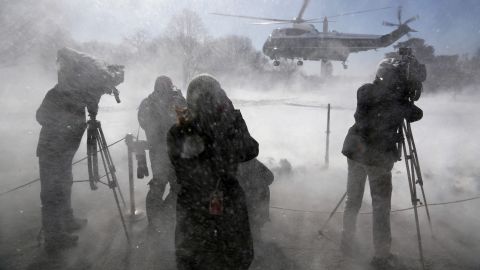 Reporters are hit by snow as President Obama leaves the White House on Marine One on Friday, March 6.
