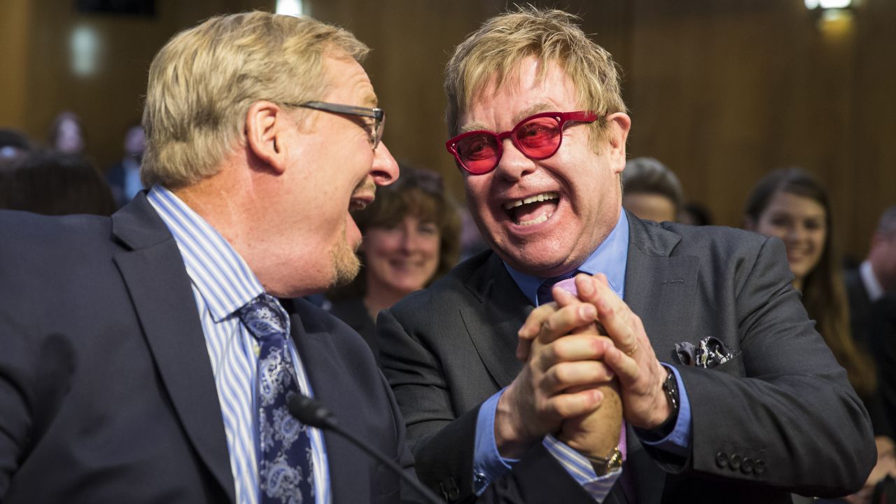 Singer Elton John, right, greets pastor Rick Warren on Wednesday, May 6, prior to testifying before a Senate subcommittee in Washington. The singer supports U.S. funding for the global treatment for HIV and AIDS.