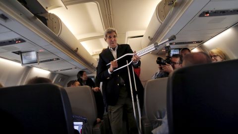 U.S. Secretary of State John Kerry plays with his crutches as he talks to reporters aboard a plane in Maryland on Friday, June 26. Kerry broke his leg riding a bike in May.