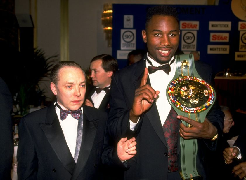 Lewis shows off his WBC belt alongside manager Maloney in 1992. 