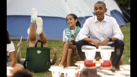 A girl near President Obama loses her balance in her chair as she and other Girl Scouts camped on the South Lawn of the White House on Tuesday, June 30.