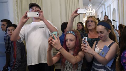 People take photos while touring the White House on Wednesday, July 1. It was the first day the White House began allowing photos to be taken during public tours.
