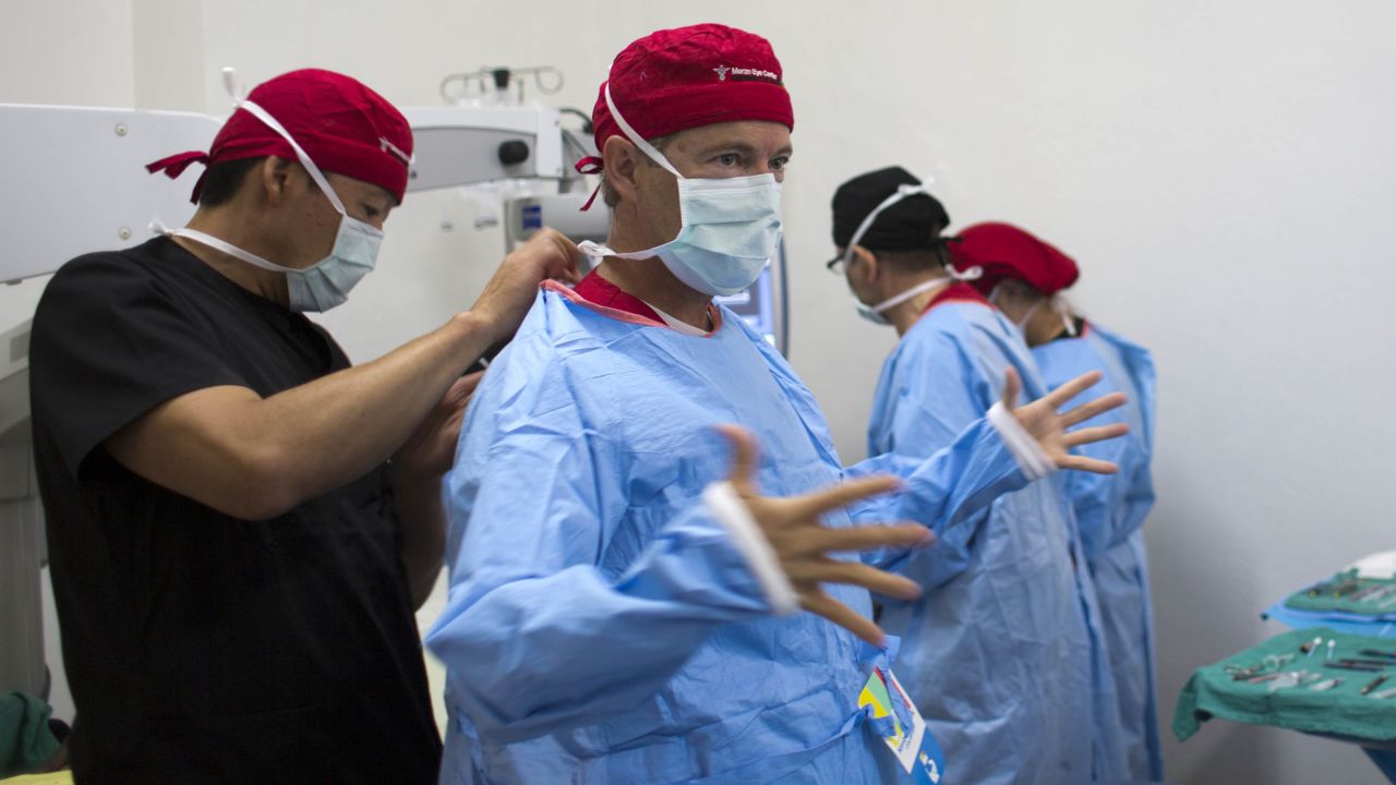 U.S. Sen. Rand Paul, the Republican presidential candidate from Kentucky who is also an ophthalmologist, gets suited up so he can perform cataract surgery in Haiti on Monday, August 17. While the humanitarian trip was not technically part of Paul's campaign, he invited a small number of political journalists and at least one prominent donor to join him.