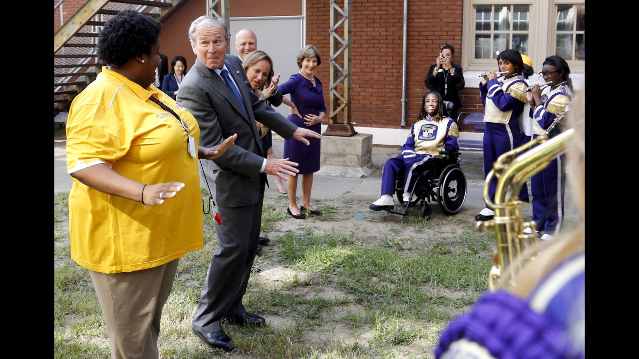Former President George W. Bush dances along with the Warren Easton High School marching band during a trip to New Orleans on Friday, August 28. Bush's visit came as the city prepared to mark the 10th anniversary of Hurricane Katrina.