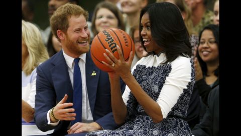 First lady Michelle Obama and Britain's Prince Harry watch a basketball game played by wounded service members and veterans Wednesday, October 28, at Fort Belvoir, Virginia. Prince Harry was on <a href="http://www.cnn.com/2015/10/28/us/gallery/prince-harry-in-u-s-/index.html" target="_blank">a one-day visit</a> to the Washington area.