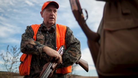 Republican presidential candidate Mike Huckabee, left, speaks with U.S. Rep. Steve King while hunting pheasant Sunday, November 1, in northwestern Iowa. A few other Republican candidates also took part in the fundraising event.