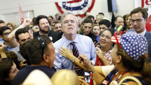 Republican presidential candidate Jeb Bush allows a supporter to loosen his tie during a campaign rally in Tampa, Florida, on Monday, November 2.