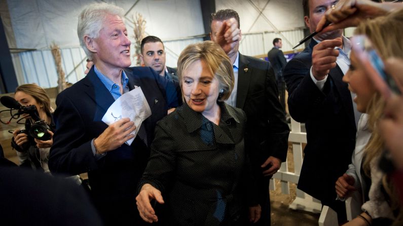 Democratic presidential candidate Hillary Clinton and her husband, former U.S. President Bill Clinton, greet supporters at a barbecue event in Ames, Iowa, on Sunday, November 15.