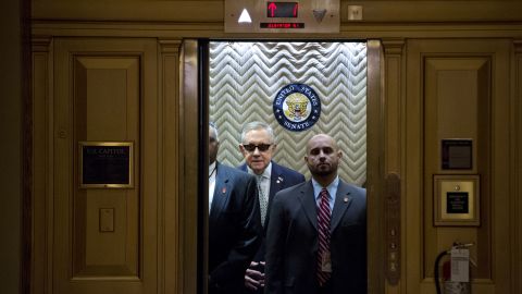 Senate Minority Leader Harry Reid, in the sunglasses, boards an elevator at the Capitol after signing a condolence book Tuesday, November 17, for victims of the Paris terrorist attacks.