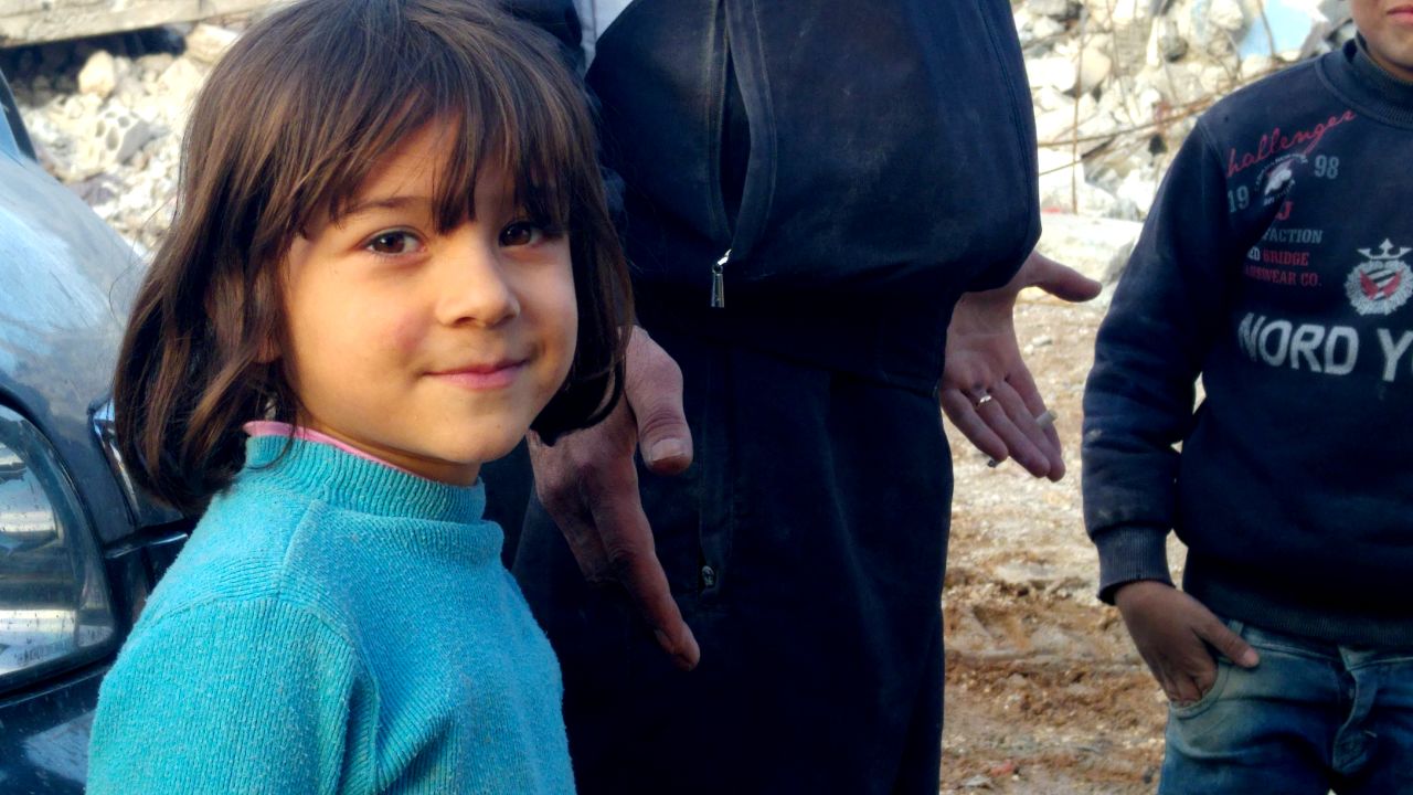 A young resident of Kobani. She stood by her father, Mustafa Ismail, who watched silently for hours as a bulldozer hauled away the remains of his three-story house.