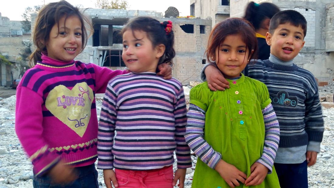 These children stopped playing on top of the ruins of a school to pose for this photo. They thought the CNN crew were funny. They laughed.