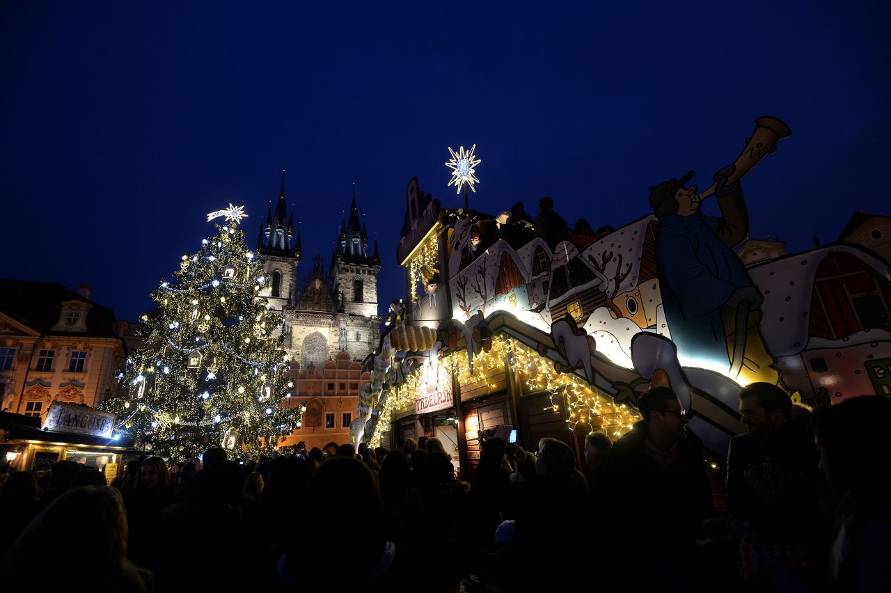 An illuminated tree lights the market at the Old Town Square in Prague, Czech Republic.