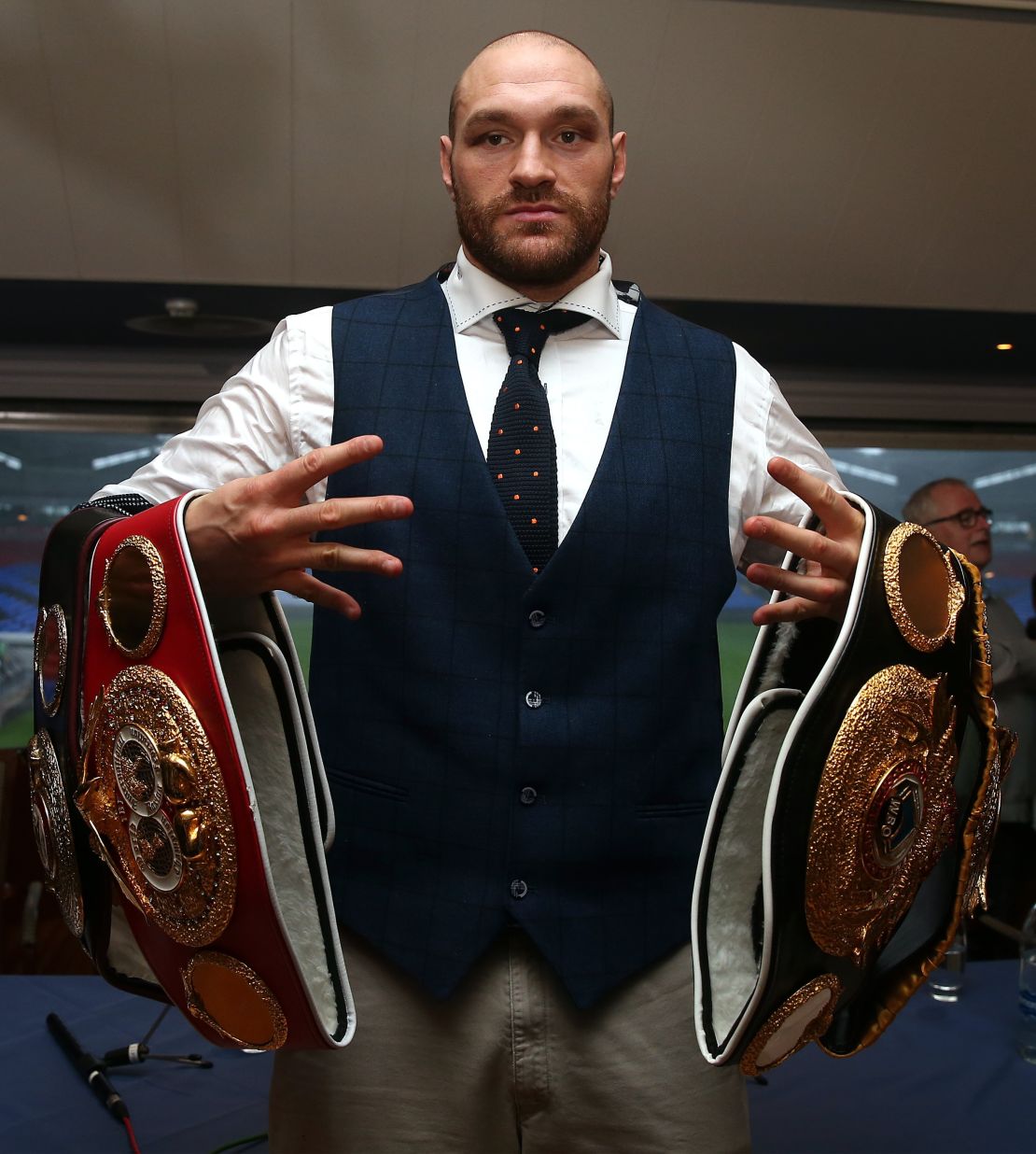 Tyson Fury poses with his heavyweight belts in happier times.