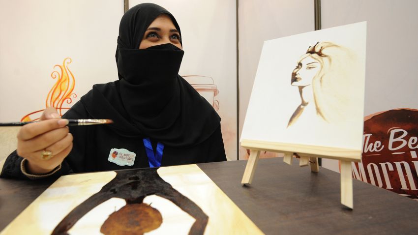 A Saudi woman paints using Arabic coffee during the International Coffee and Chocolate Exhibition in the desert kingdom's capital Riyadh on December 15, 2014. AFP PHOTO / FAYEZ NURELDINE        (Photo credit should read FAYEZ NURELDINE/AFP/Getty Images)