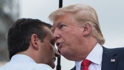 US Republican presidential candidate Donald Trump (R) is greeted on stage by fellow Republican candidate Ted Cruz before speaking at a rally organized by the Tea Party Patriots against the Iran nuclear deal in front of the Capitol in Washington, DC, on September 9, 2015.