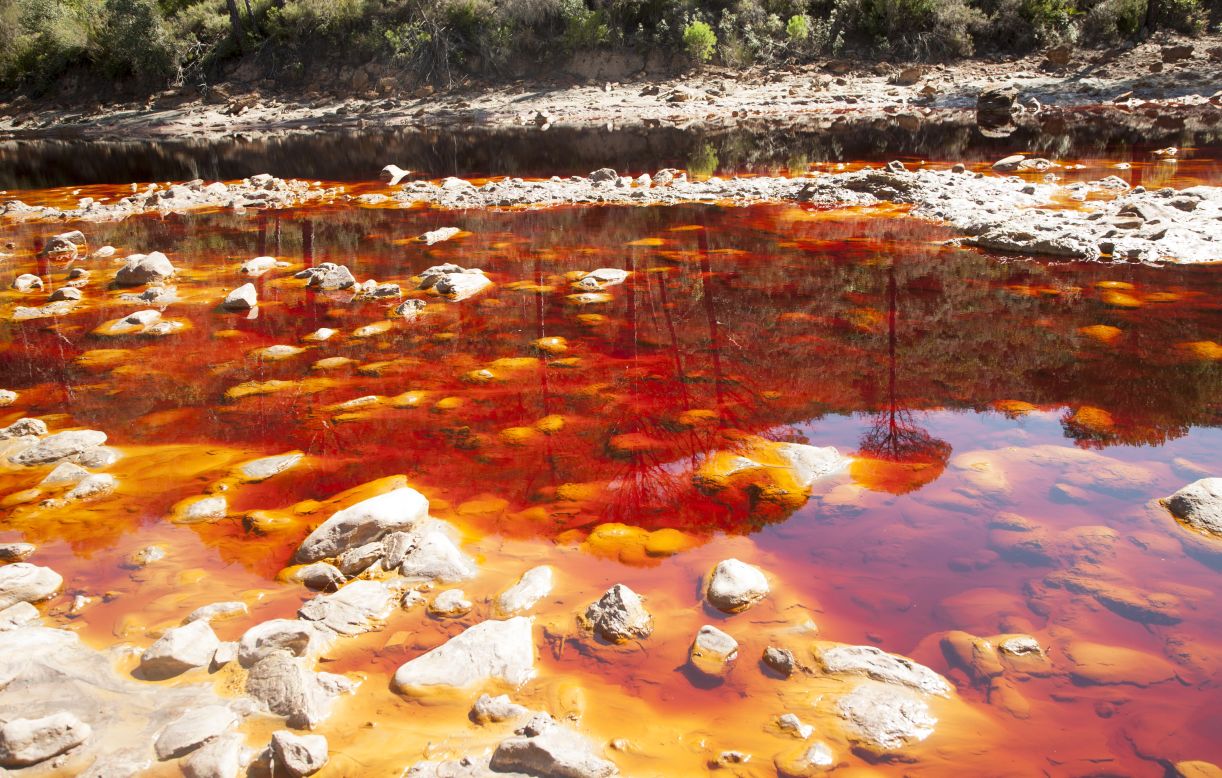 The Rio Tinto in southwestern Spain runs through a mineral-rich area that has been mined for thousands of years. Iron deposits in the water give the river its reddish color.