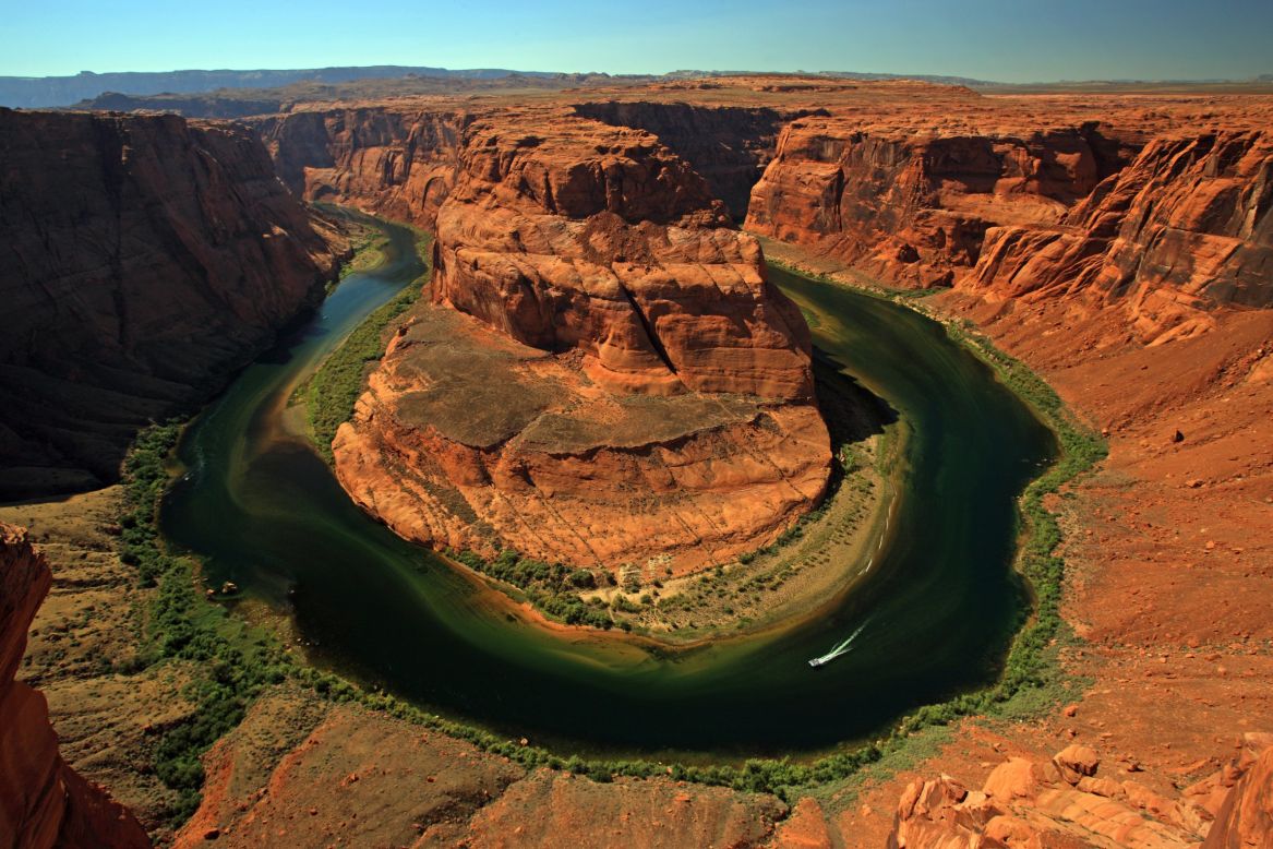 Rivers have their own way of meandering through the world. The Colorado River meanders in spectacular fashion at Horseshoe Bend near Page, Arizona. An overlook 1,000 feet above the river provides a sinuous view.