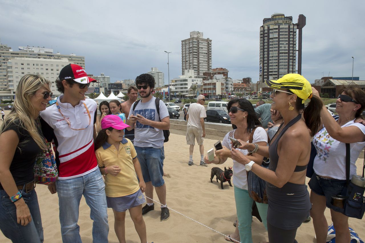 Mahindra Racing's star driver Bruno Senna poses with fans on the sand at the Punta del Este resort in 2014.
