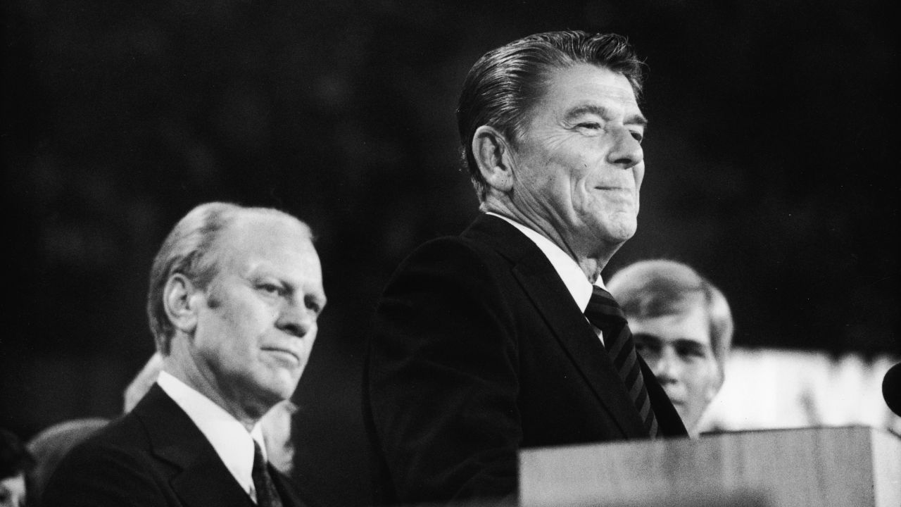 President Gerald Ford listens as Ronald Reagan delivers a speech during the closing session of the Republican National Convention on August 19, 1976 in Kansas City, Missouri.