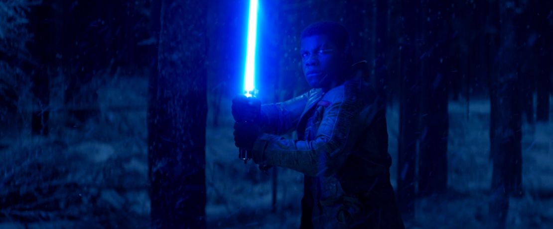 Finn in "The Force Awakens" with Luke's lightsaber.