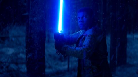 Finn in "The Force Awakens" with Luke's lightsaber.