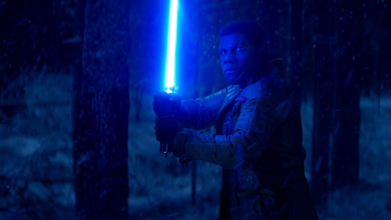 Finn in "The Force Awakens" with Luke's lightsaber.