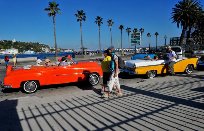 U.S. tourists crowd into old American cars in Havana. Cuba is scrambling to accommodate an influx of visitors.
