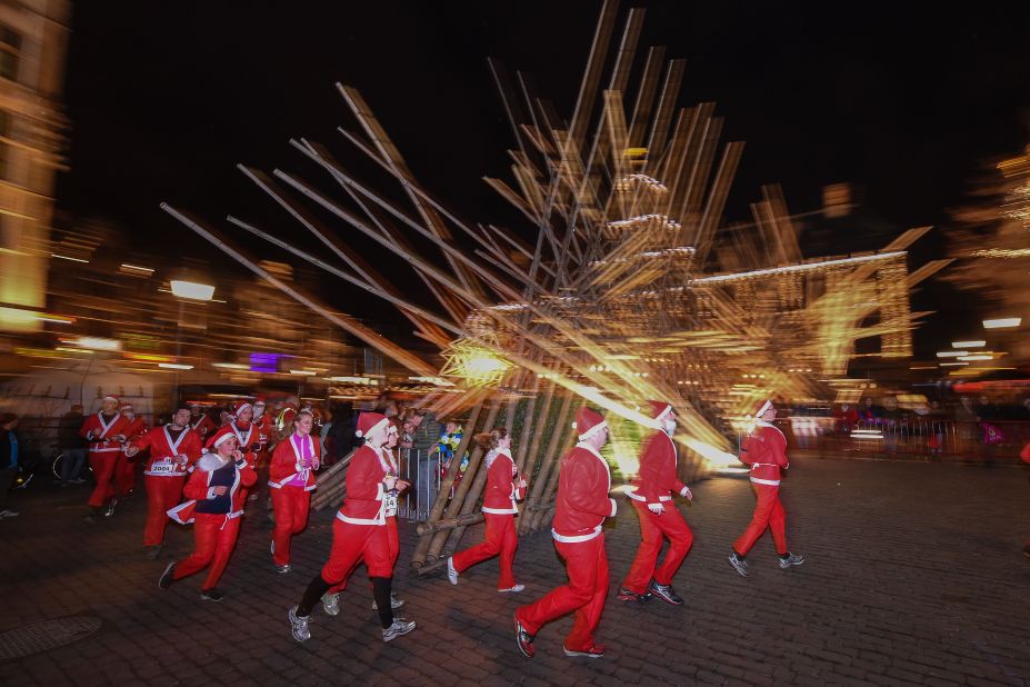 Runners dressed as Santa Claus make their way through the Grote Markt in Antwerp, Belgium, during a Santa Run on Saturday December 12. 