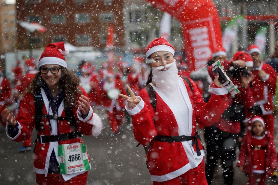 Runners cross the finish line of the Santa Claus "Papa Noel" race in Madrid, Spain. Around 10,000 adults dressed as Santas took part in the race. 