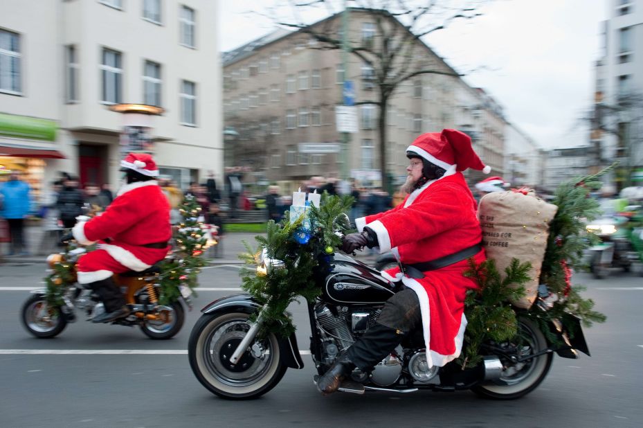Men costumed as Santa Claus ride motorcycles during the annual  "Berlin Christmas Biketour" in Berlin, Germany,. 