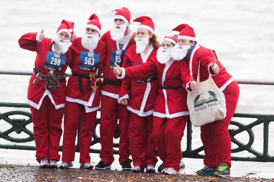 Runners taking part in the yearly Brighton Santa Dash in aid of Brighton's Chrildren's Charity Rockinghorse, pose for a photograph in East Sussex, England.