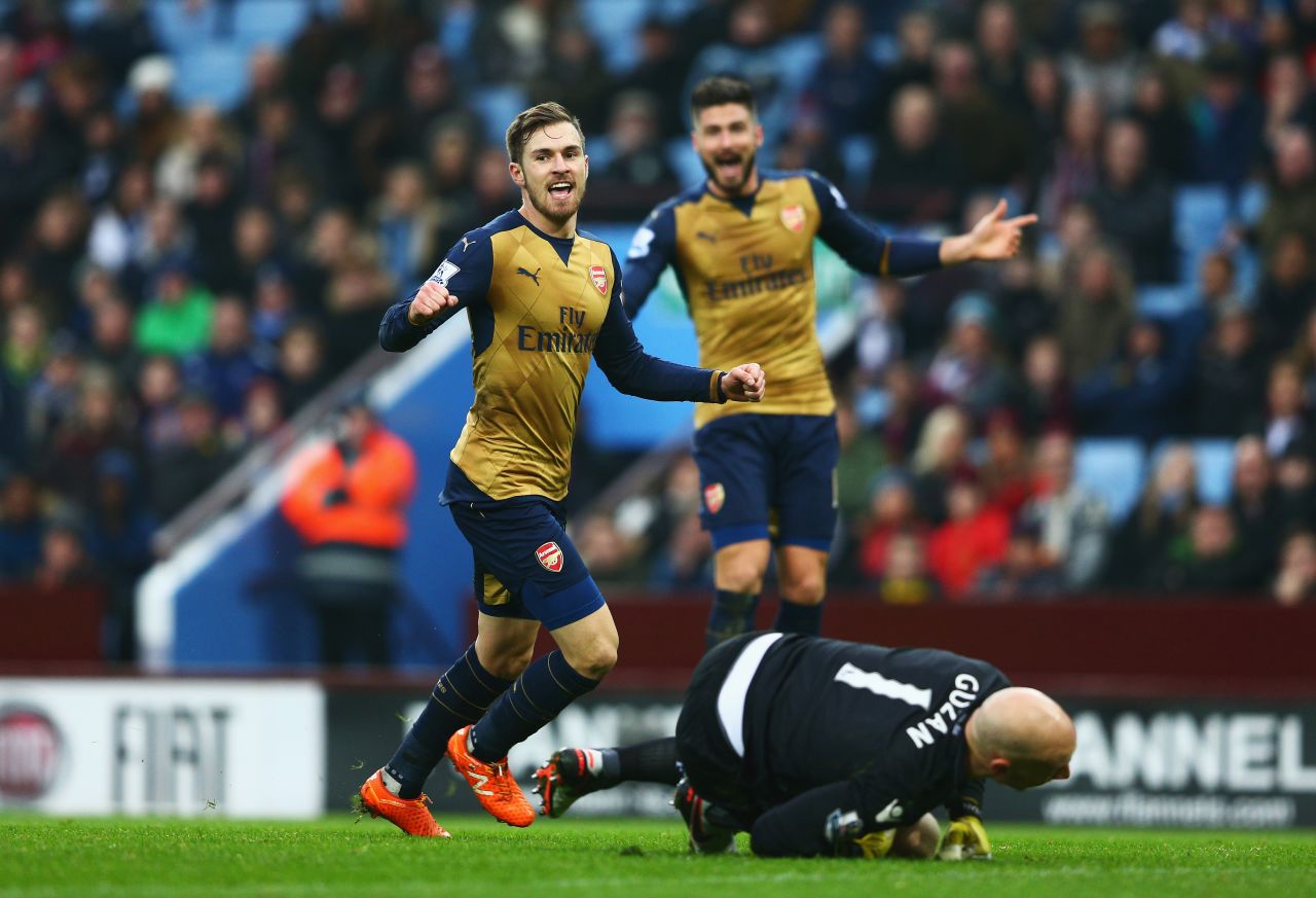 Aaron Ramsey of Arsenal celebrates as he scores his team's second goal against Aston Villa at Villa Park. Arsenal topped the standings after the 2-0 victory.