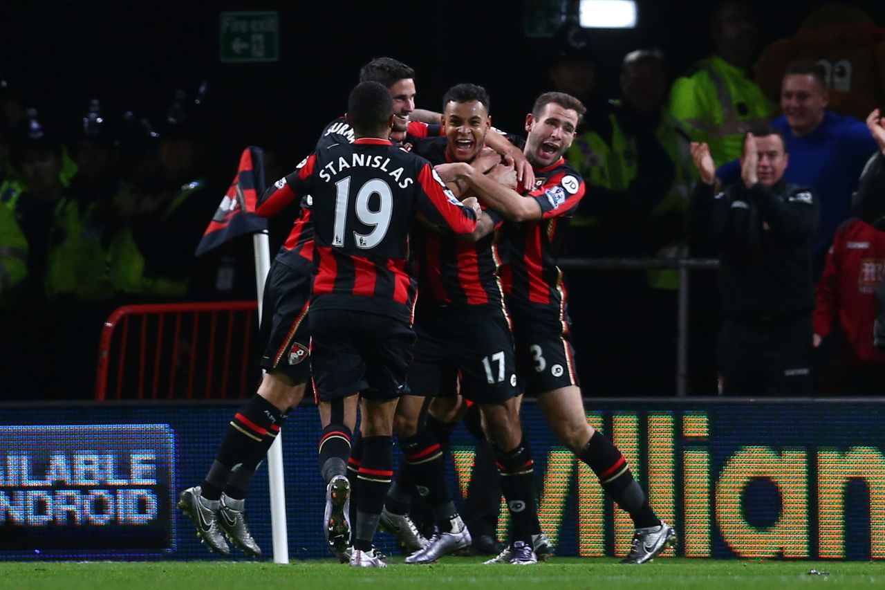 Joshua King (second right) is mobbed by teammates after scoring his team's vital second goal in the 2-1 victory over Manchester United.