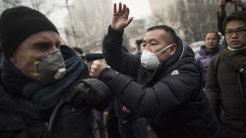 Chinese police push away journalists and supporters of human rights lawyer Pu Zhiqiang demonstrating near the Beijing Second Intermediate People's Court in Beijing on December 14, 2015. One of China's most celebrated human rights lawyers went on trial December 14 over online comments critical of the ruling Communist Party, as police scuffled with supporters and journalists gathered outside the courthouse. AFP PHOTO / FRED DUFOUR / AFP / FRED DUFOUR        (Photo credit should read FRED DUFOUR/AFP/Getty Images)