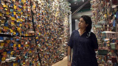 Indian artist Hema Upadhyay poses in front of her "Think Left, Think Right, Think Low, Think Tight" installation at the Paris's Pompidou Centre on May 23, 2011.