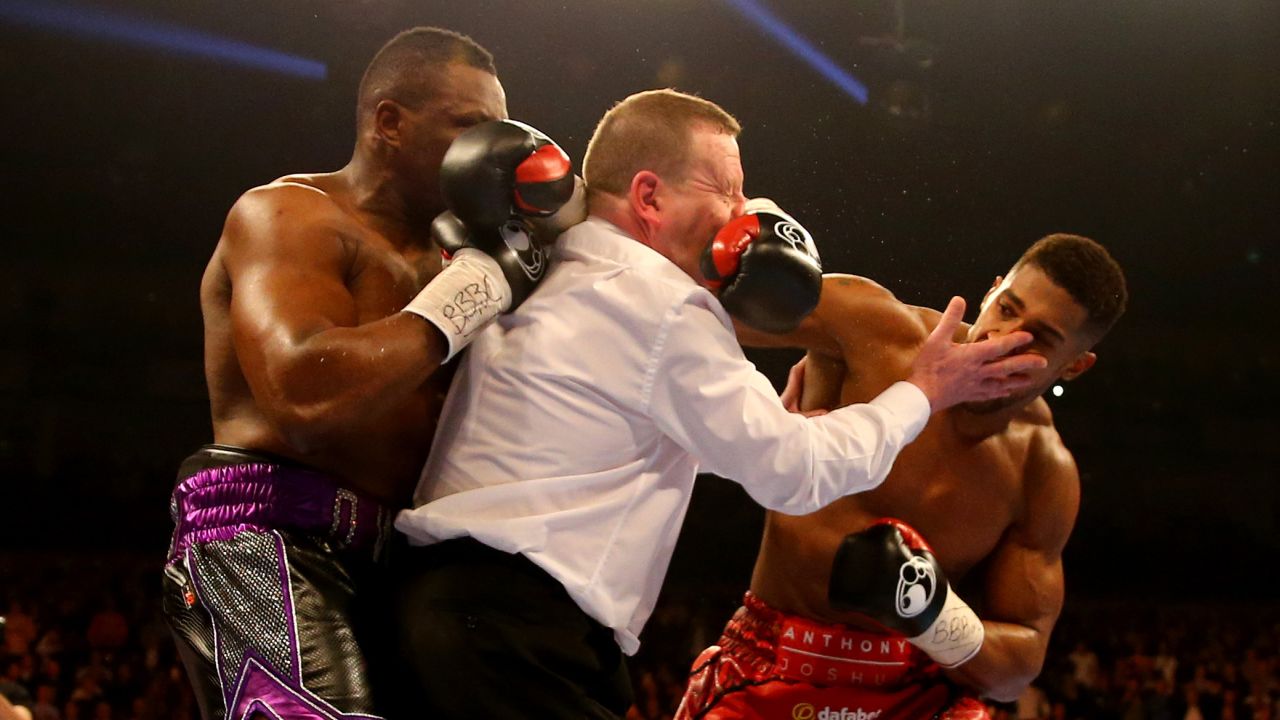 Anthony Joshua, right, throws a punch after the end of the first round Saturday, December 12, in London. Joshua stopped Dillian Whyte in the seventh round to win the British heavyweight title and improve his record to 15-0.