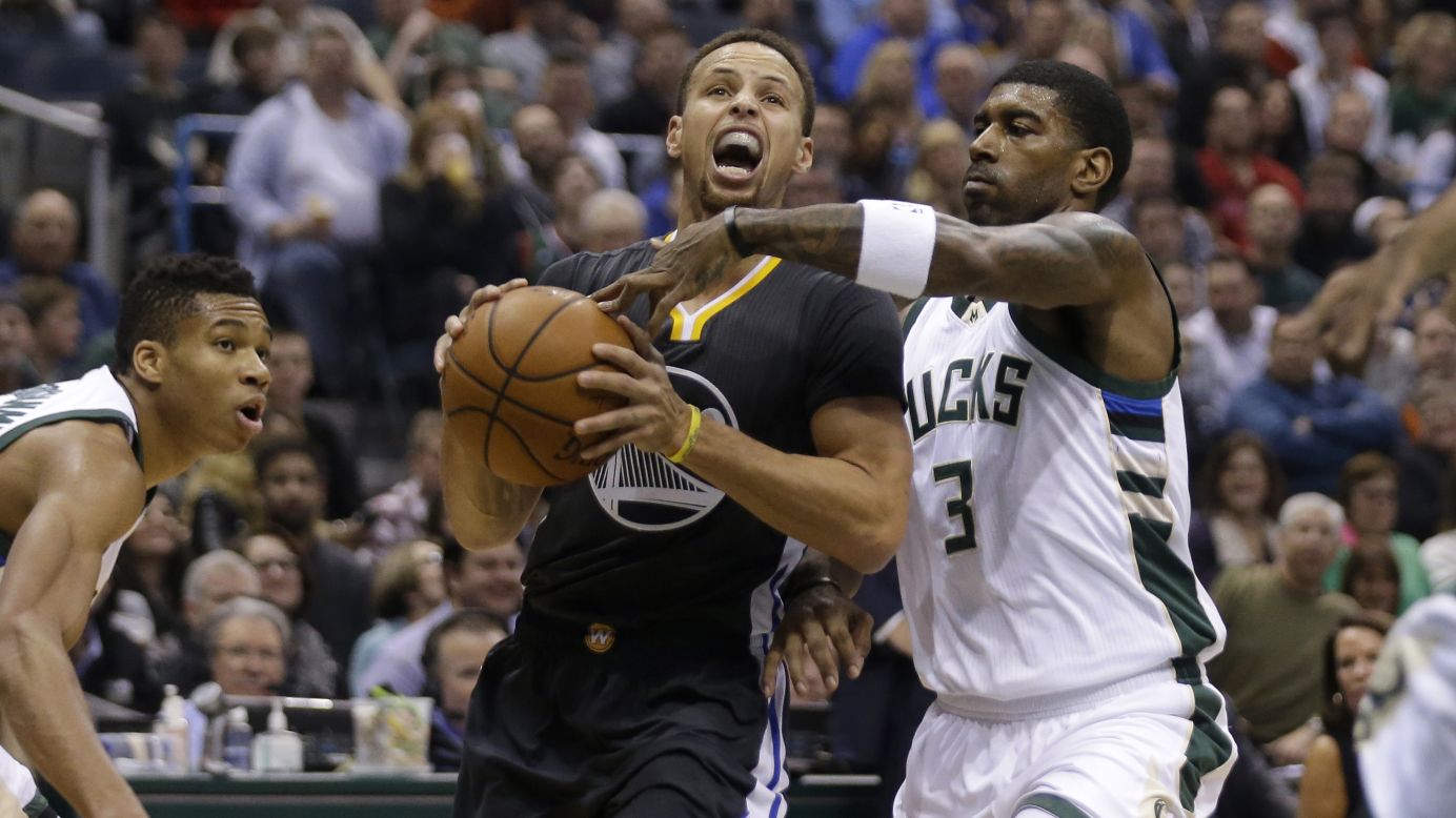 Golden State star Stephen Curry is guarded by O.J. Mayo during an NBA game in Milwaukee on Saturday, December 12. Mayo and the Bucks handed the Warriors their first loss of the season, dropping the defending champions to 24-1. It was the league's best-ever start.