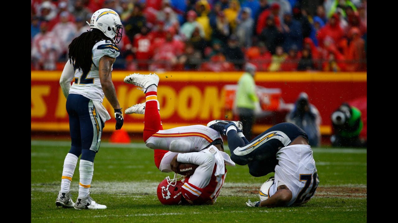 San Diego's Denzel Perryman, right, and Kansas City's Demetrius Harris mirror each other after a tackle Sunday, December 13, in Kansas City, Missouri.