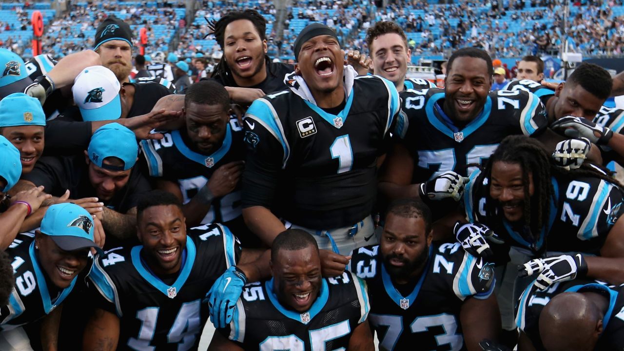 Cam Newton (No. 1) and the Carolina Panthers celebrate Sunday, December 13, after they shut out Atlanta 38-0 to clinch a first-round playoff bye. The Panthers (13-0) are the NFL's only undefeated team this season.