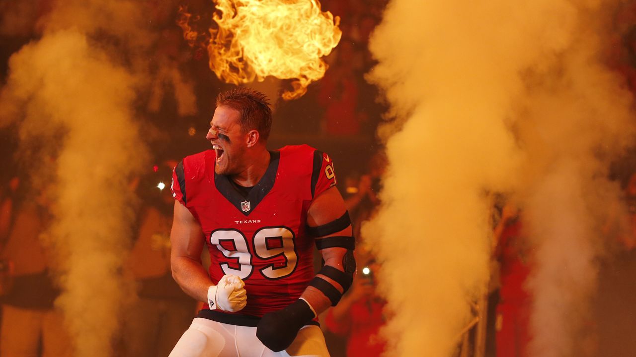 Houston defensive end J.J. Watt is introduced to the home crowd before an NFL game against New England on Sunday, December 13. Watt played with a cast on his left hand.