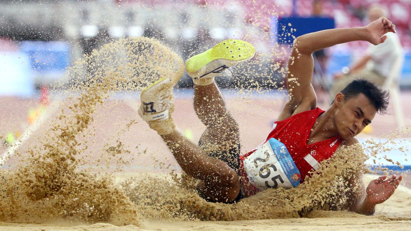 Singapore's Suhairi Suhani lands in the sand pit after a long jump at the ASEAN Para Games on Tuesday, December 8. He won silver in the event.