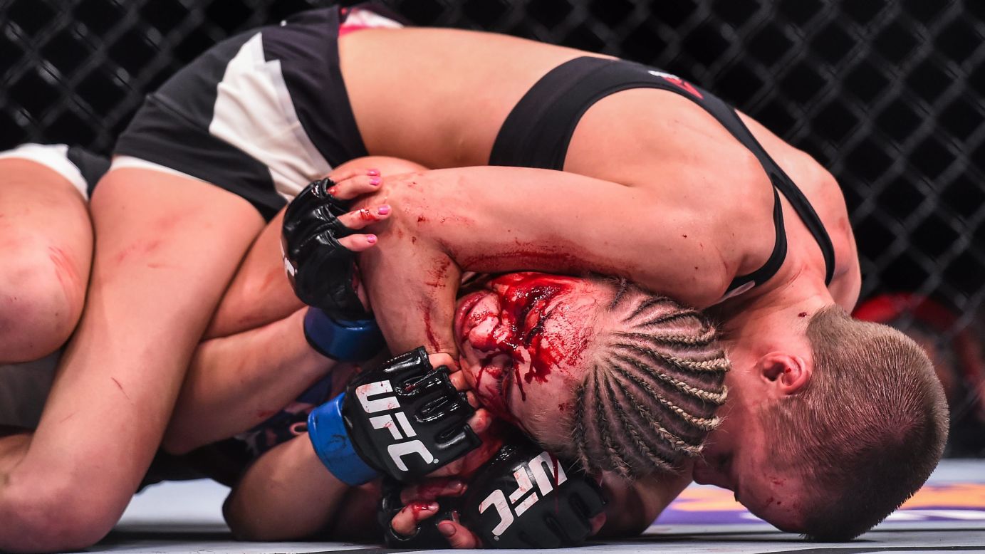 Rose Namajunas grapples with a bloody Paige VanZant during their UFC bout in Las Vegas on Thursday, December 10. Namajunas won via fifth-round submission.