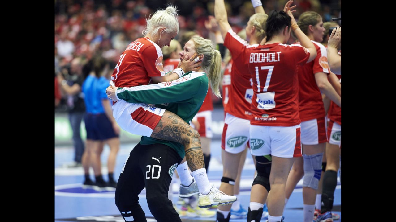 Teammates Kristina Kristiansen, left, and Rikke Poulsen celebrate Sunday, December 13, after Denmark won its round-of-16 match at the Handball World Championship.