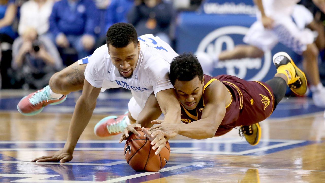 Kentucky's Isaiah Briscoe, left, and Arizona State's Tra Holder dive for a loose ball during a game in Lexington, Kentucky, on Saturday, December 12.