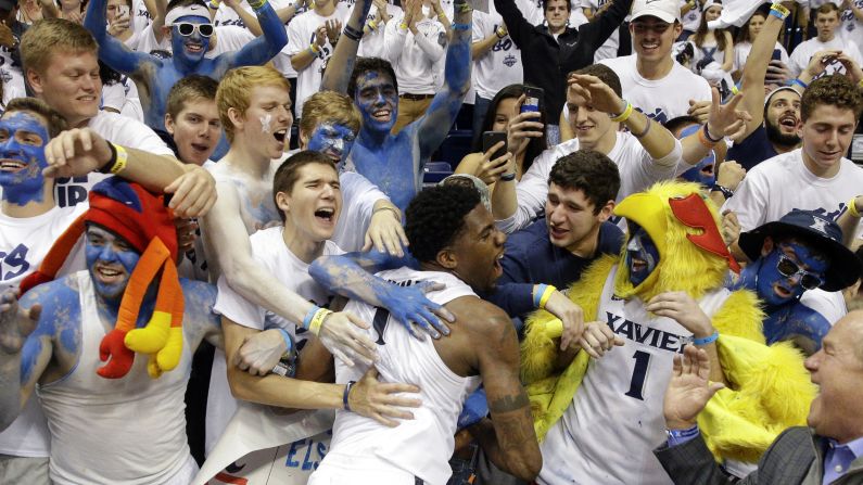 Xavier basketball player Jalen Reynolds celebrates with fans after the Musketeers defeated crosstown rival Cincinnati on Saturday, December 12.