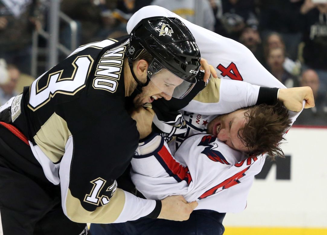 Taylor Chorney of the Washington Capitals, right, fights Nick Bonino of the Pittsburgh Penguins during an NHL game in Pittsburgh on Monday, December 14.