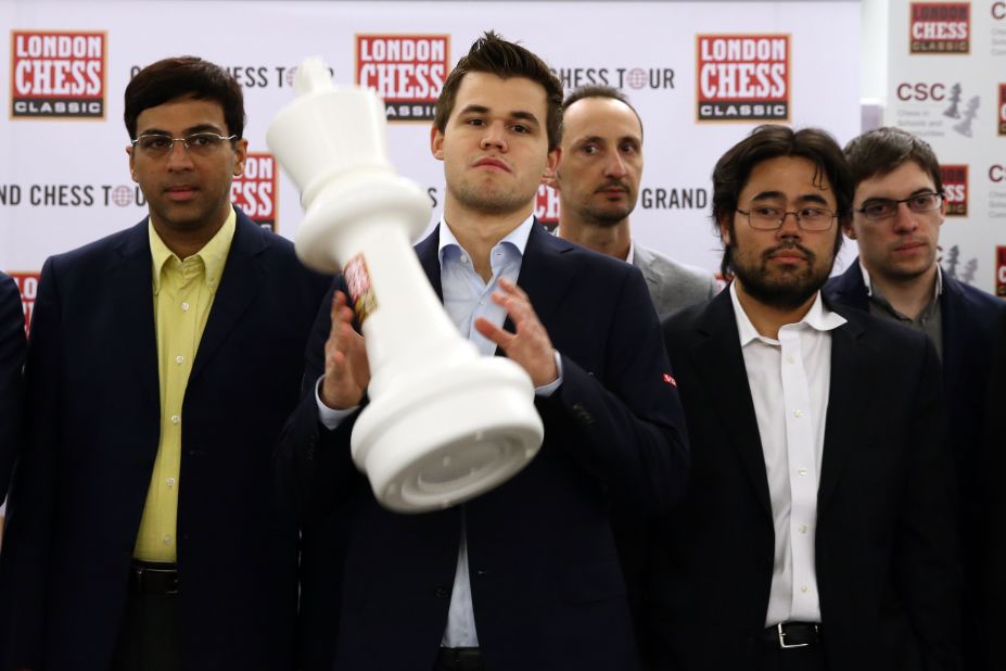 World No. 1 chess player, Magnus Carlsen, celebrates after winning the prestigious 2015 London Chess Classic... surrounded by some less-than-enthusiastic opponents. 