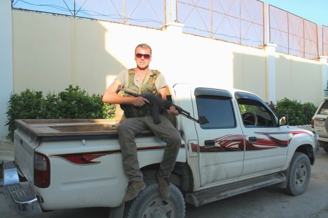 Drury started visiting danger zones for the excitement and enjoyed getting close to military action. Here he's pictured in Mogadishu with a weapon borrowed from his security detail. <br />