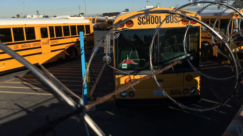 Los Angeles School District buses are parked at their bus garage in Gardena, Calif., Tuesday, Dec. 15, 2015. The nation's second-largest school district shut down Tuesday after a school board member received an emailed threat that raised fears of another attack like the deadly shooting in nearby San Bernardino. (AP Photo/Damian Dovarganes)